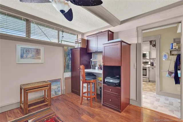 a view of a room with furniture and wooden floor