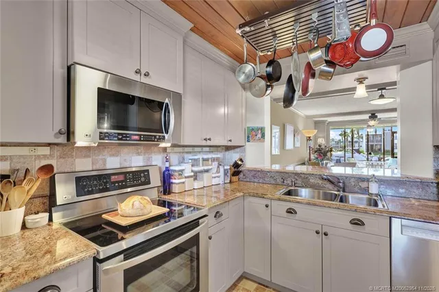a kitchen with stainless steel appliances a stove microwave and refrigerator