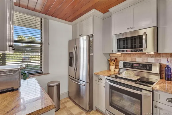 a kitchen with a sink a stove and microwave