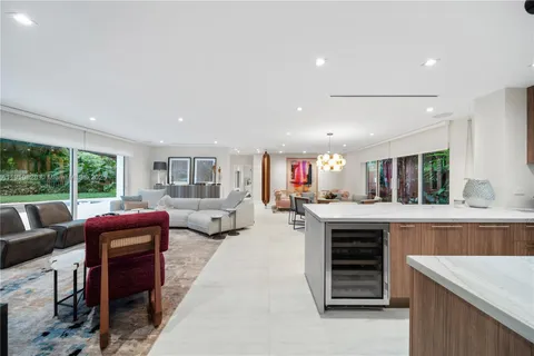 a kitchen with stainless steel appliances a sink a stove cabinets counter space and a window