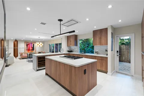 a kitchen with stainless steel appliances a stove a sink and a refrigerator