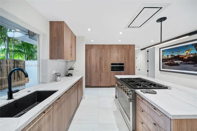 a kitchen with stainless steel appliances granite countertop a stove and a sink