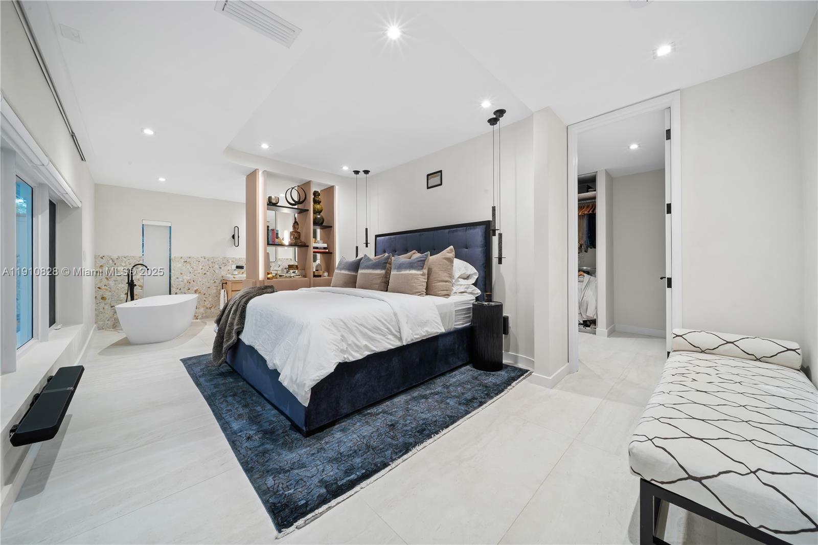 1075 Northeast 99th Street Miami Shores, FL 33138 - Photo 27 of 63 a bedroom with a large bed and a couch