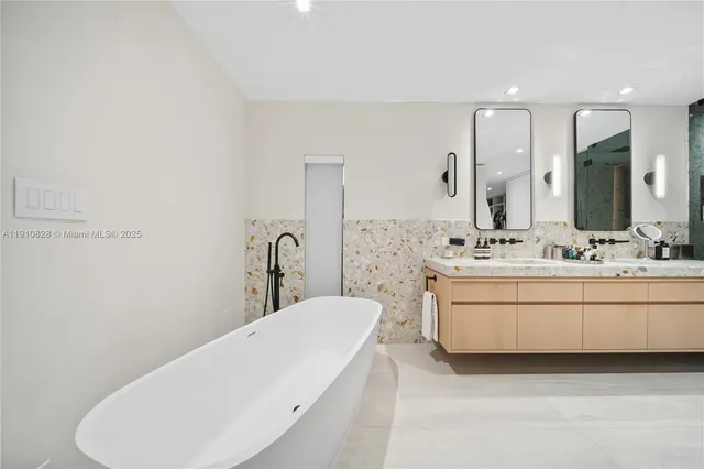 a bathroom with a tub sink and mirror