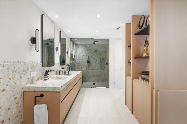 a bathroom with a granite countertop sink a shower and a mirror