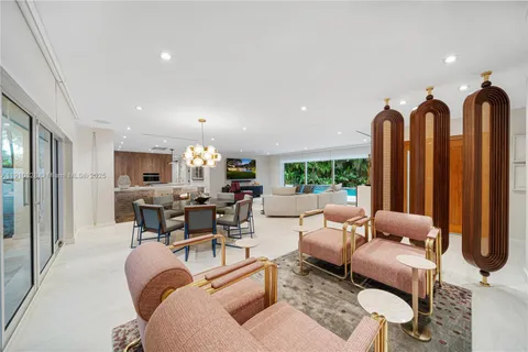 a living room with furniture a lamp and a chandelier