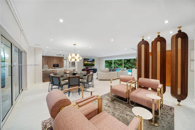 a living room with furniture a lamp and a chandelier