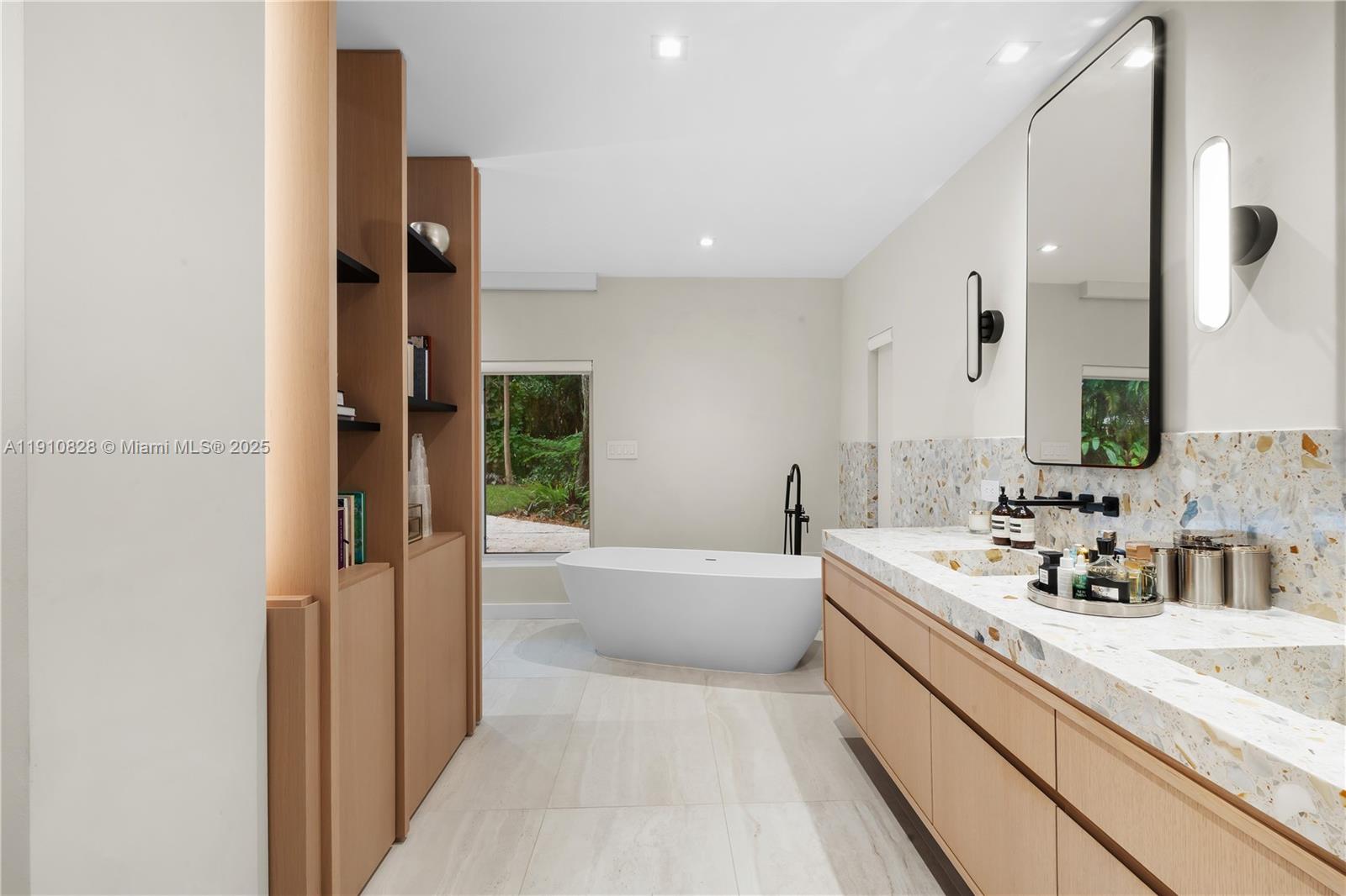 1075 Northeast 99th Street Miami Shores, FL 33138 - Photo 32 of 63 a bathroom with a tub sink and mirror