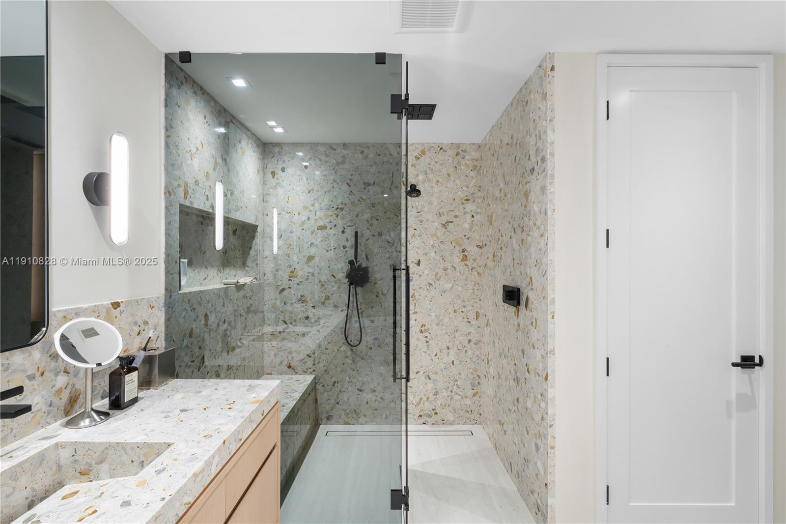 1075 Northeast 99th Street Miami Shores, FL 33138 - Photo 33 of 63 a bathroom with a granite countertop sink a shower and a mirror