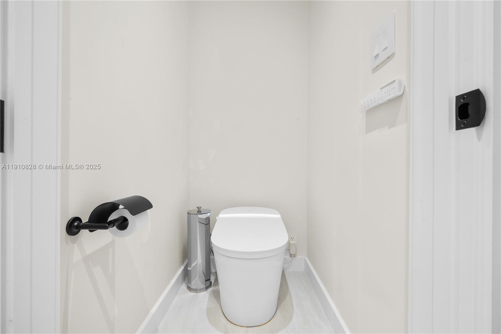 1075 Northeast 99th Street Miami Shores, FL 33138 - Photo 34 of 63 a bathroom with a toilet and a mirror