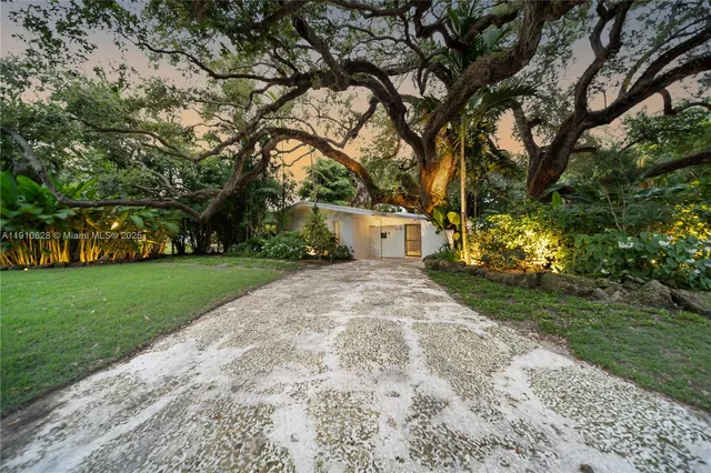 a living room with furniture and a book shelf