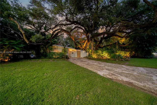 a bedroom with a large bed and a large window