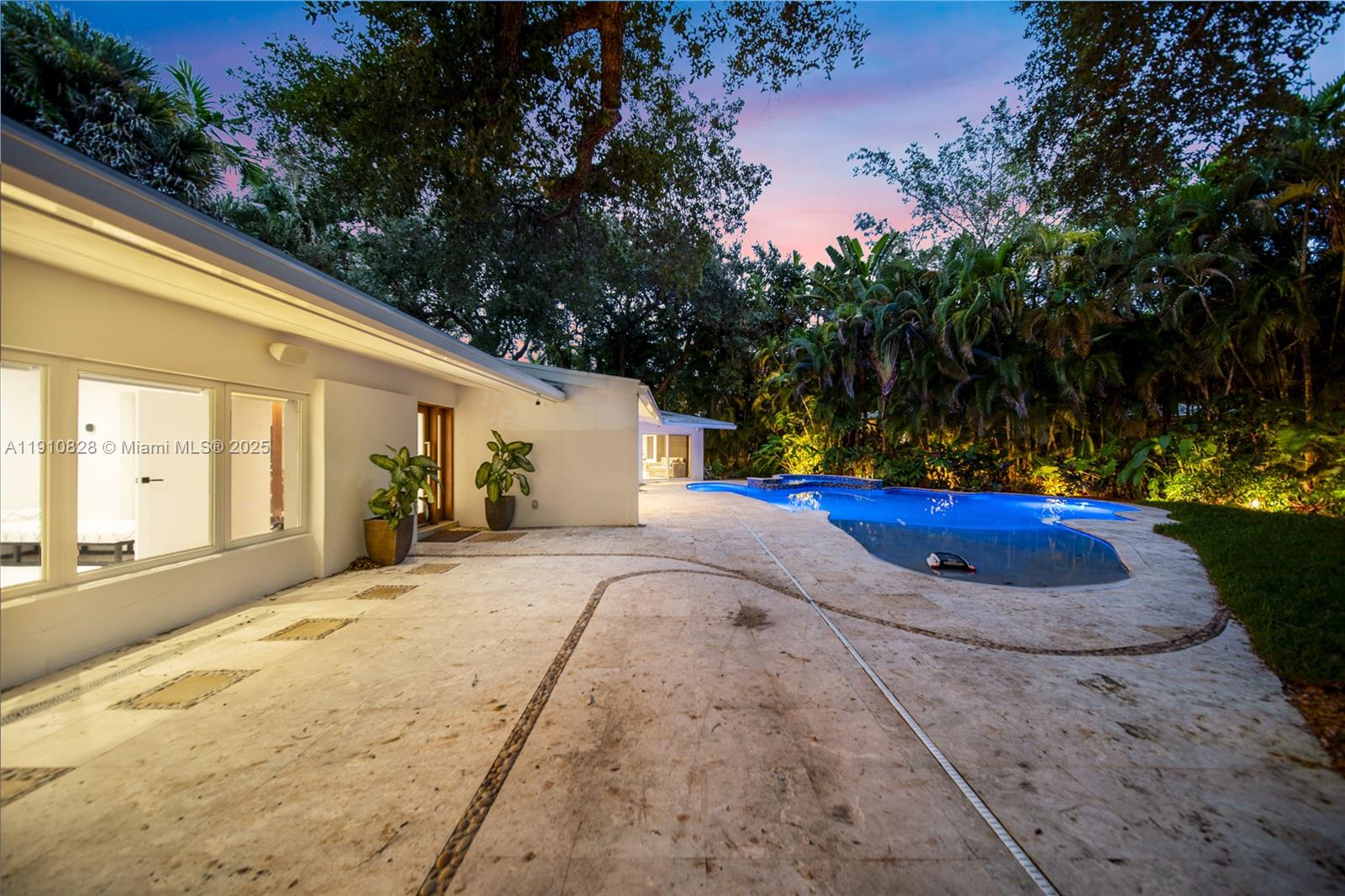 1075 Northeast 99th Street Miami Shores, FL 33138 - Photo 50 of 63 a view of a house with backyard and trees