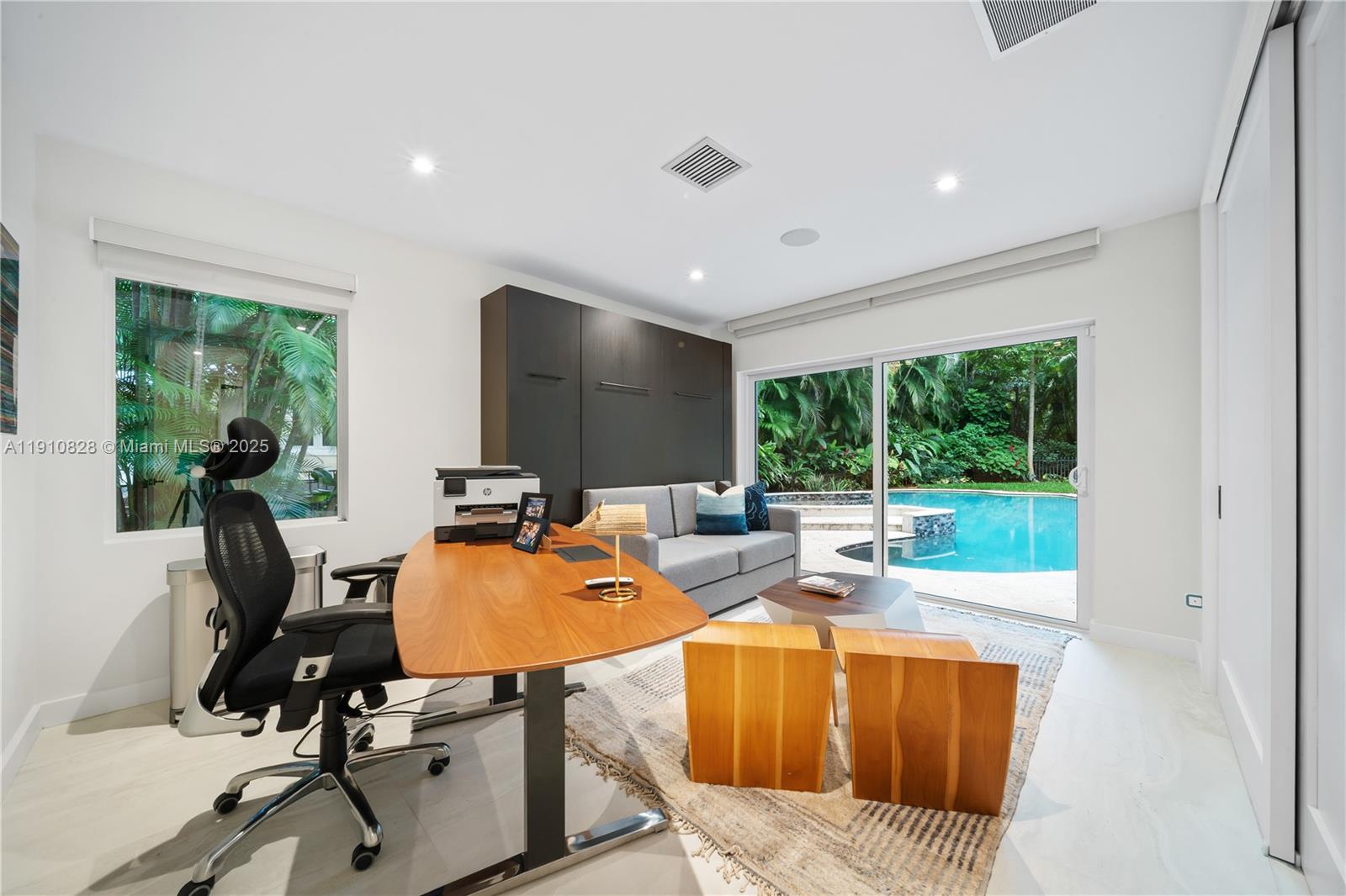 1075 Northeast 99th Street Miami Shores, FL 33138 - Photo 58 of 63 a living room with furniture a window and gym equipment