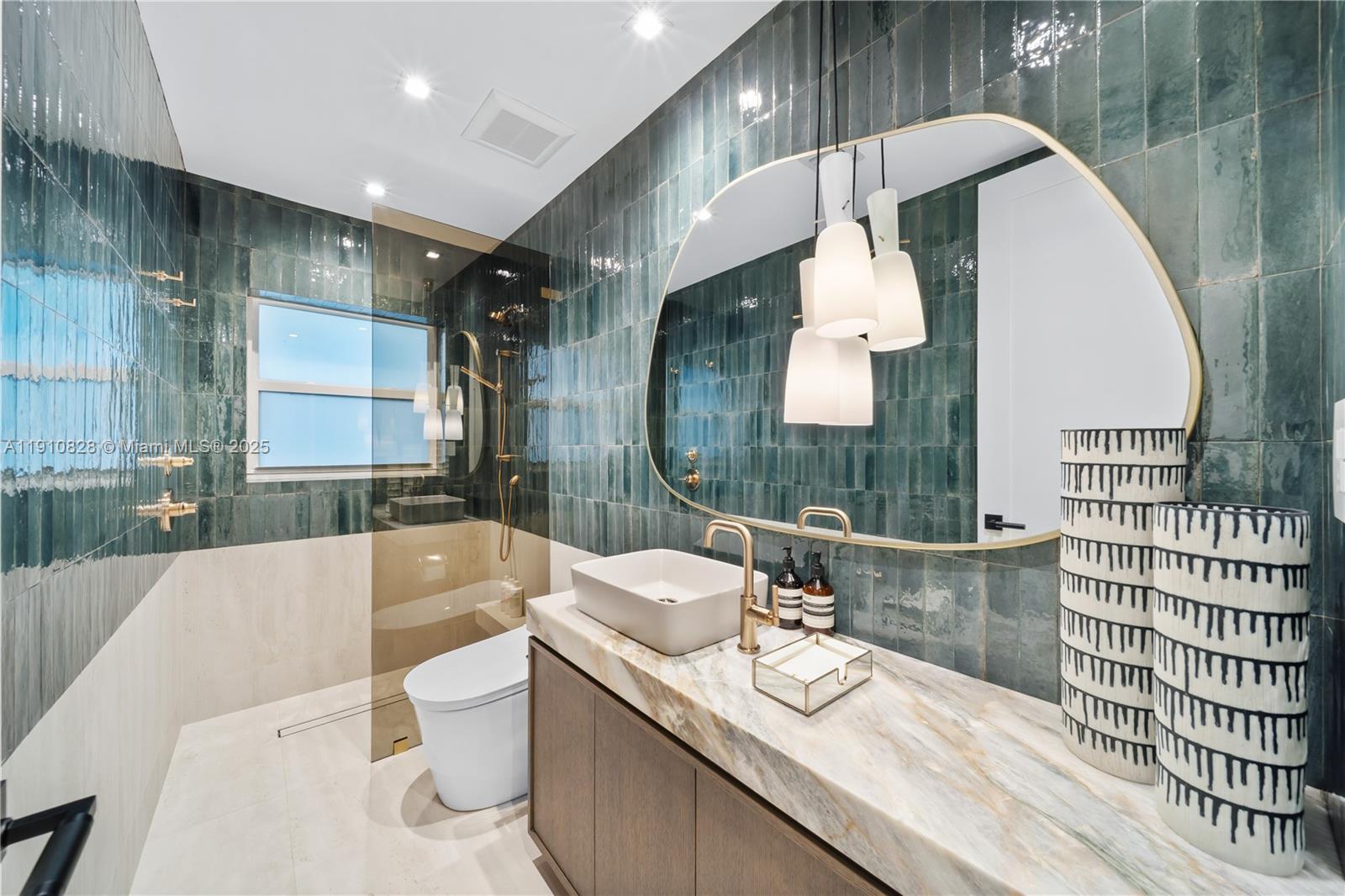 1075 Northeast 99th Street Miami Shores, FL 33138 - Photo 60 of 63 a bathroom with a granite countertop sink a toilet a mirror and bathtub