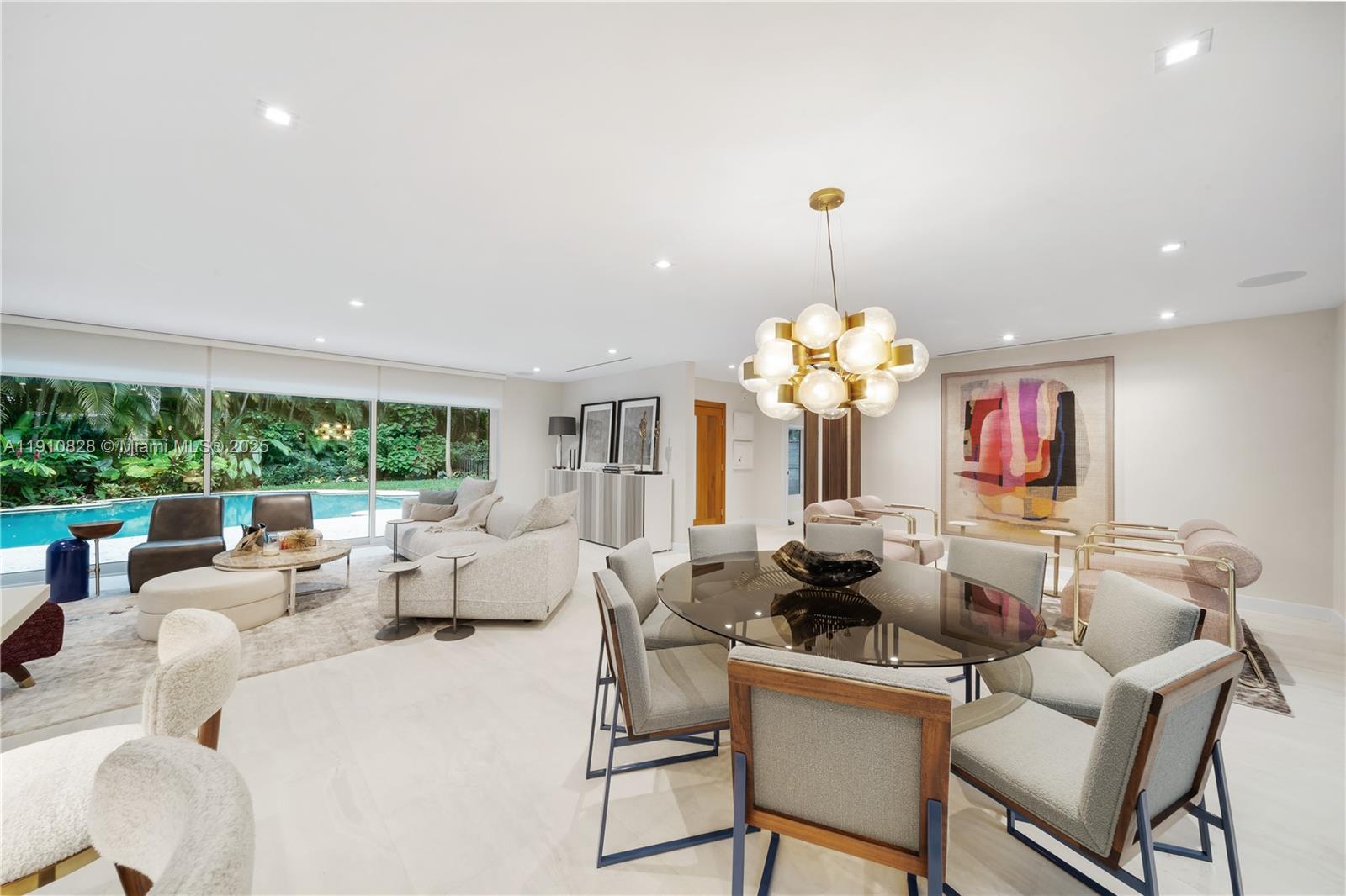1075 Northeast 99th Street Miami Shores, FL 33138 - Photo 6 of 63 a living room with furniture flowers and a chandelier