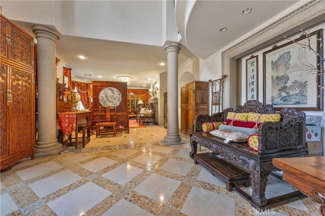 an entryway hall with a dining table and chairs
