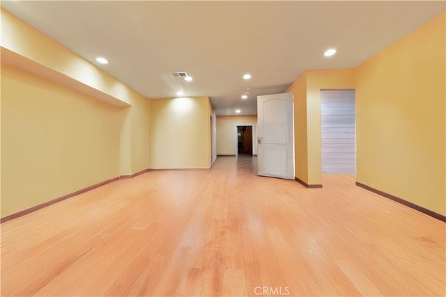 a spacious bedroom with a large bed and a large window