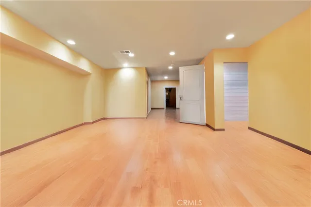 a spacious bedroom with a large bed and a large window