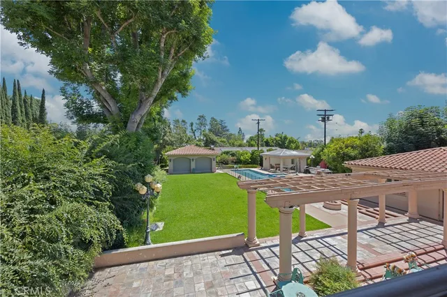 an aerial view of house with yard and mountain view in back