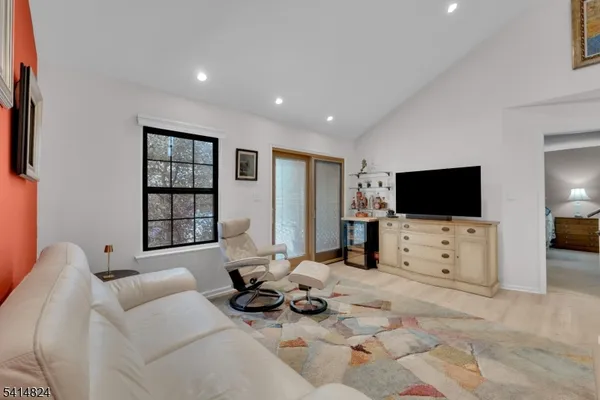 a bathroom with a granite countertop sink a toilet and shower