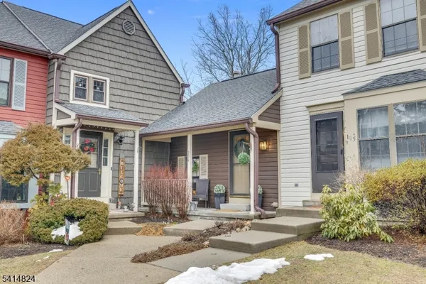 a porch with a table and chairs and potted plants