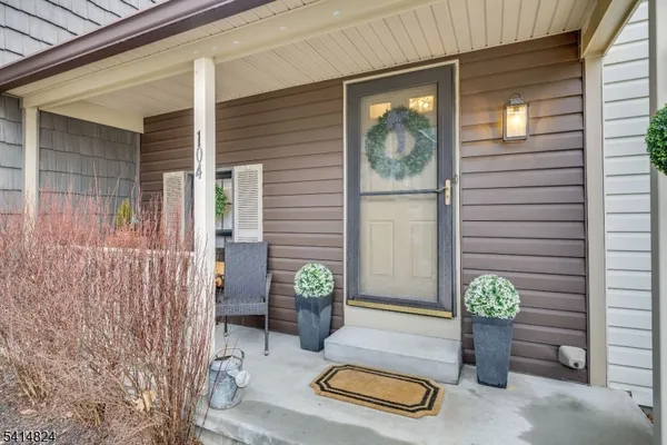 a dining room with furniture and a floor to ceiling window