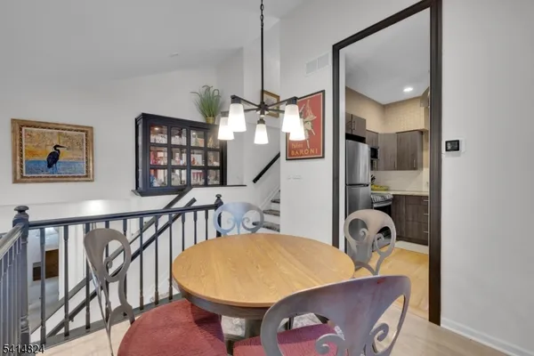 a living room with furniture a flat screen tv and kitchen view