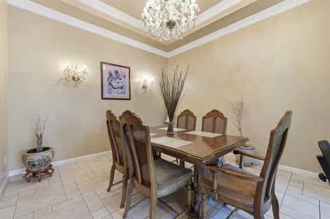 a view of a dining room with furniture and chandelier