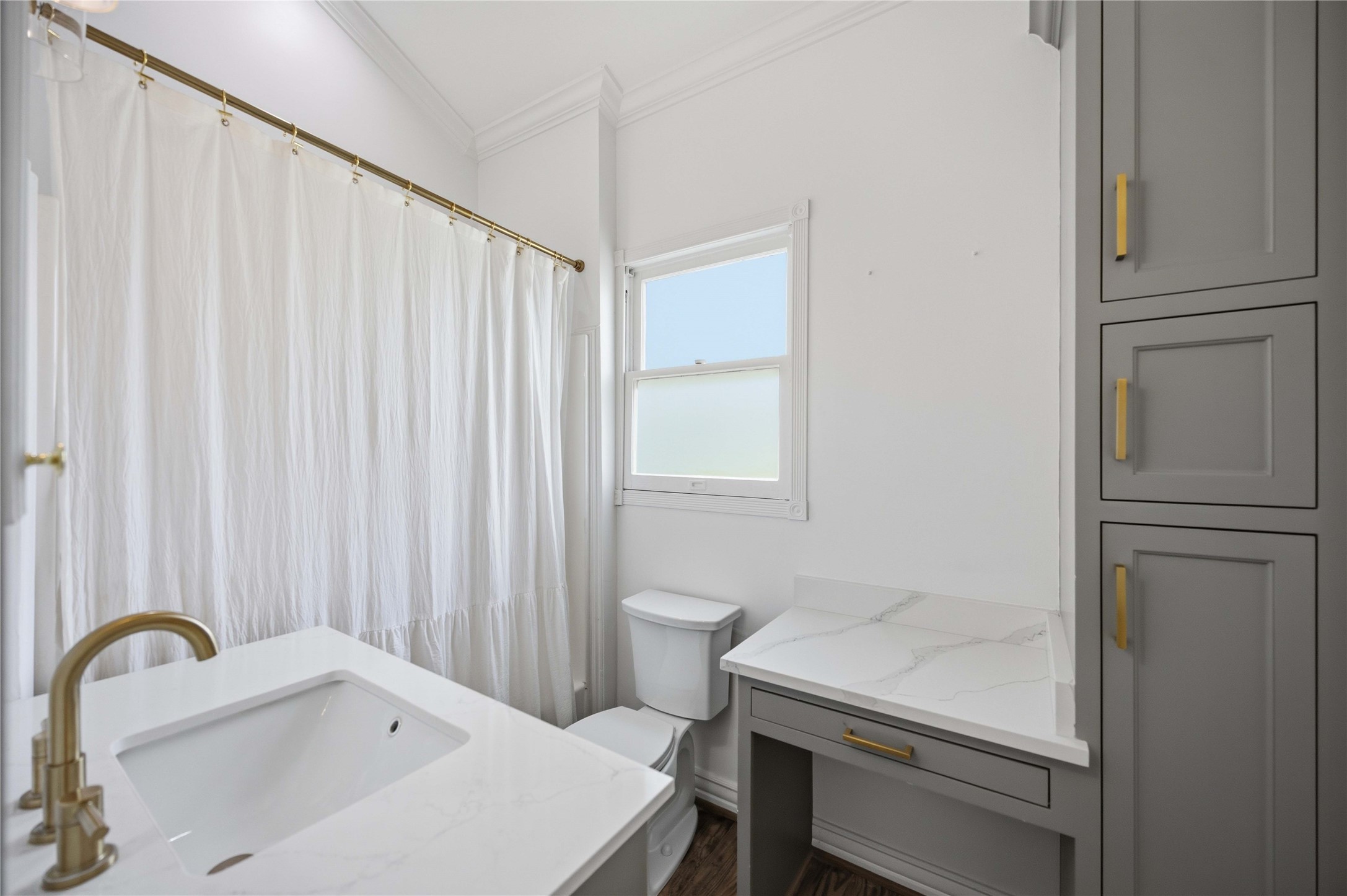 208 Archer Street Houston, TX 77009 - Photo 25 of 26 The primary bath has a vanity area and built in linen cabinet along with a combined tub and shower.