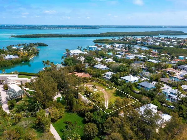 an aerial view of a house with a garden and lake view