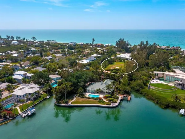 an aerial view of residential building with outdoor space and lake view in back