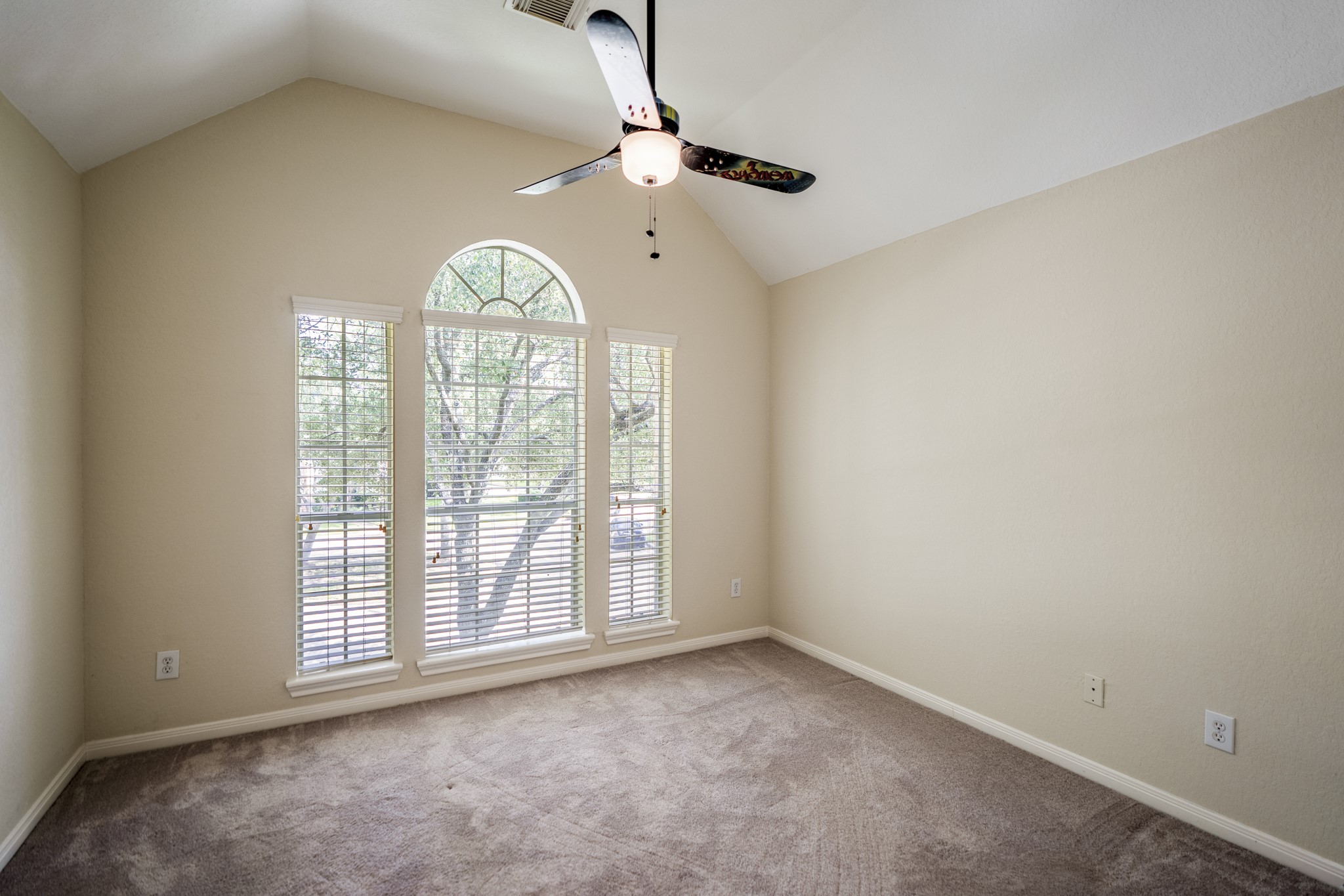5807 Sequoia Trace Court Spring, TX 77379 - Photo 25 of 50 The second bedroom brings in natural light through tall arched windows, with a vaulted ceiling that gives the room an open, airy feel while keeping it close to the game room and nearby full bath.