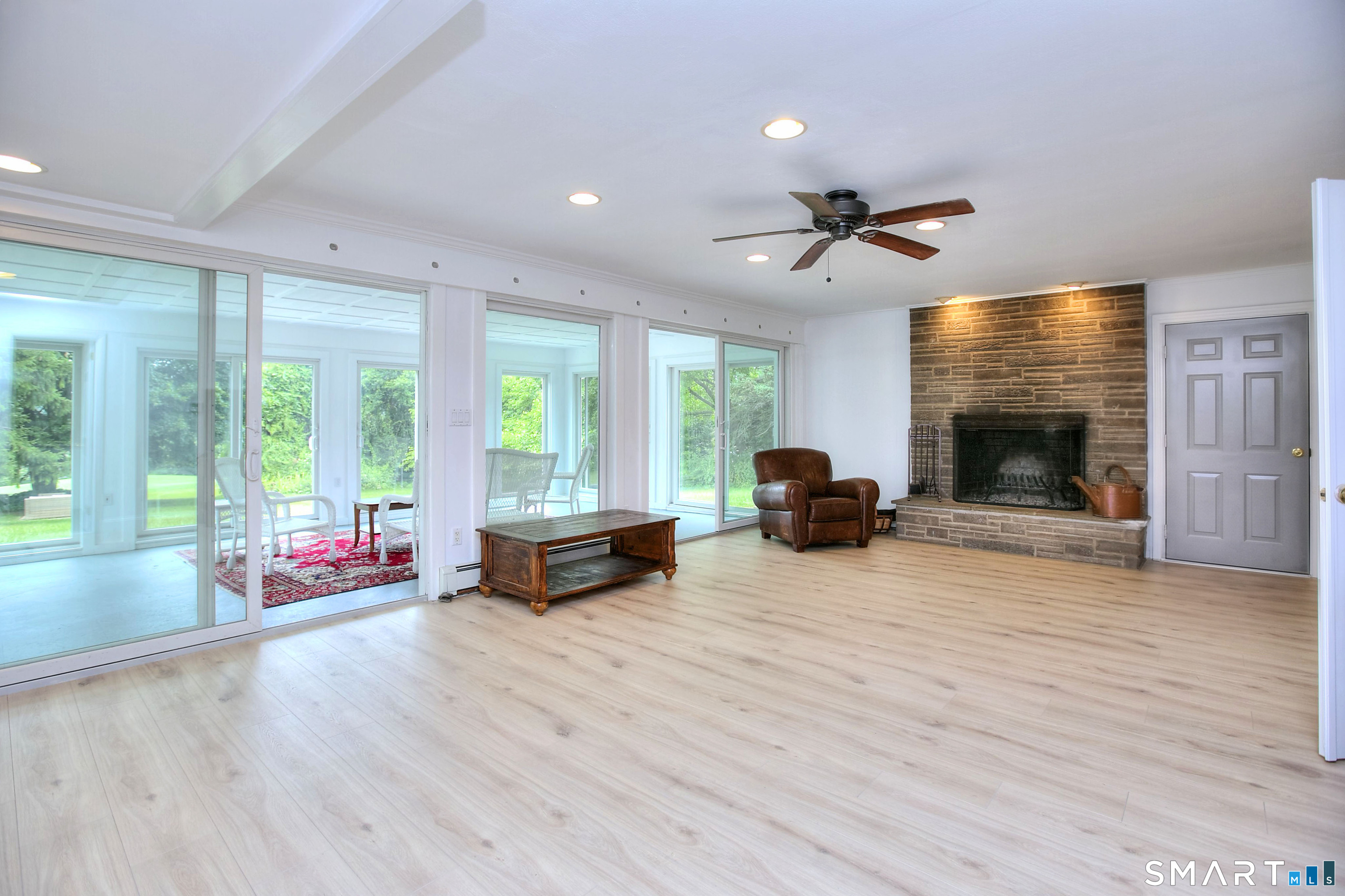 324 Ridge Road Orange, CT 06477 - Photo 15 of 38 a living room with furniture and a fireplace