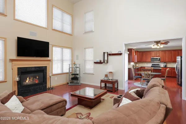 a kitchen with stainless steel appliances granite countertop wooden cabinets a sink and dishwasher with wooden floor