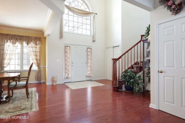 a view of a dining room with furniture wooden floor and chandelier