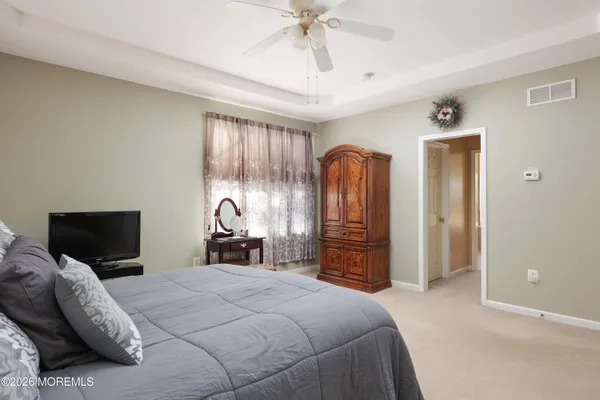 a spacious bathroom with a large tub sink and double vanity