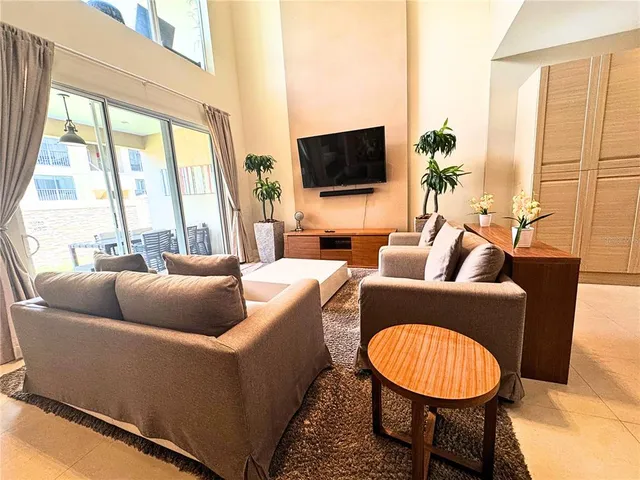 a bedroom with a bed couch and a window