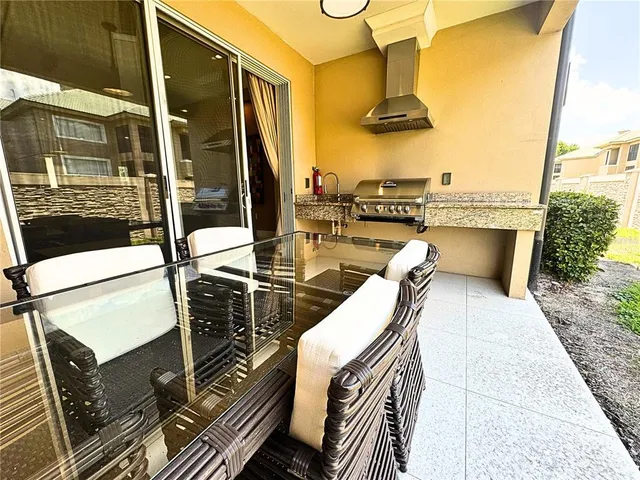 a bathroom with a granite countertop sink and a toilet