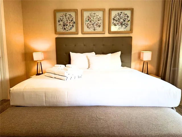 a bedroom with a bed and a night stand