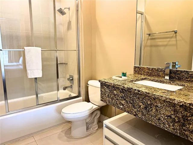a view of patio with a table and chairs and potted plants
