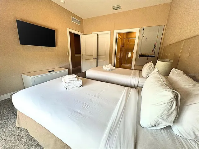 a view of a dining room with furniture one side kitchen view and wooden floor