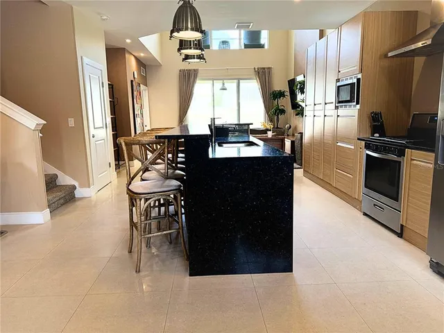 a kitchen with a sink a stove and a refrigerator