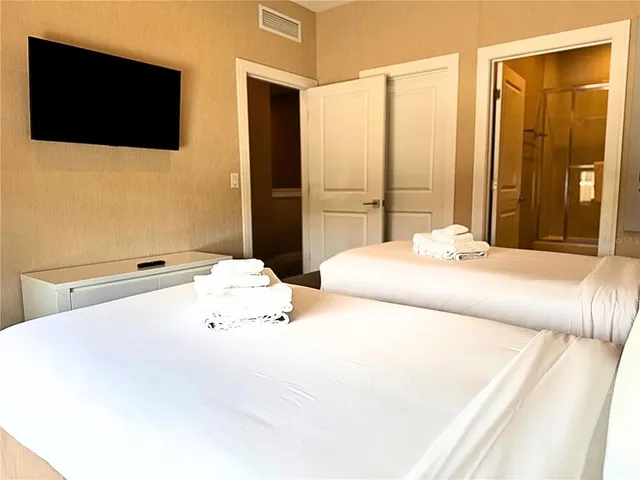 a room with lots of wooden furniture and large windows