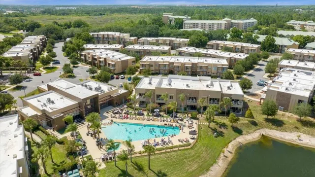 an aerial view of a house with a yard and lake view