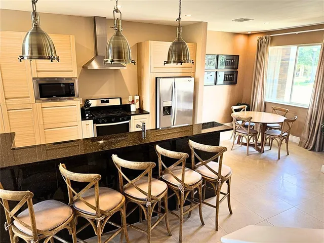 a kitchen with stainless steel appliances a refrigerator and stove