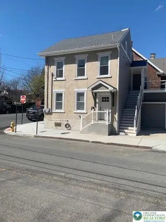 a front view of a house with a road