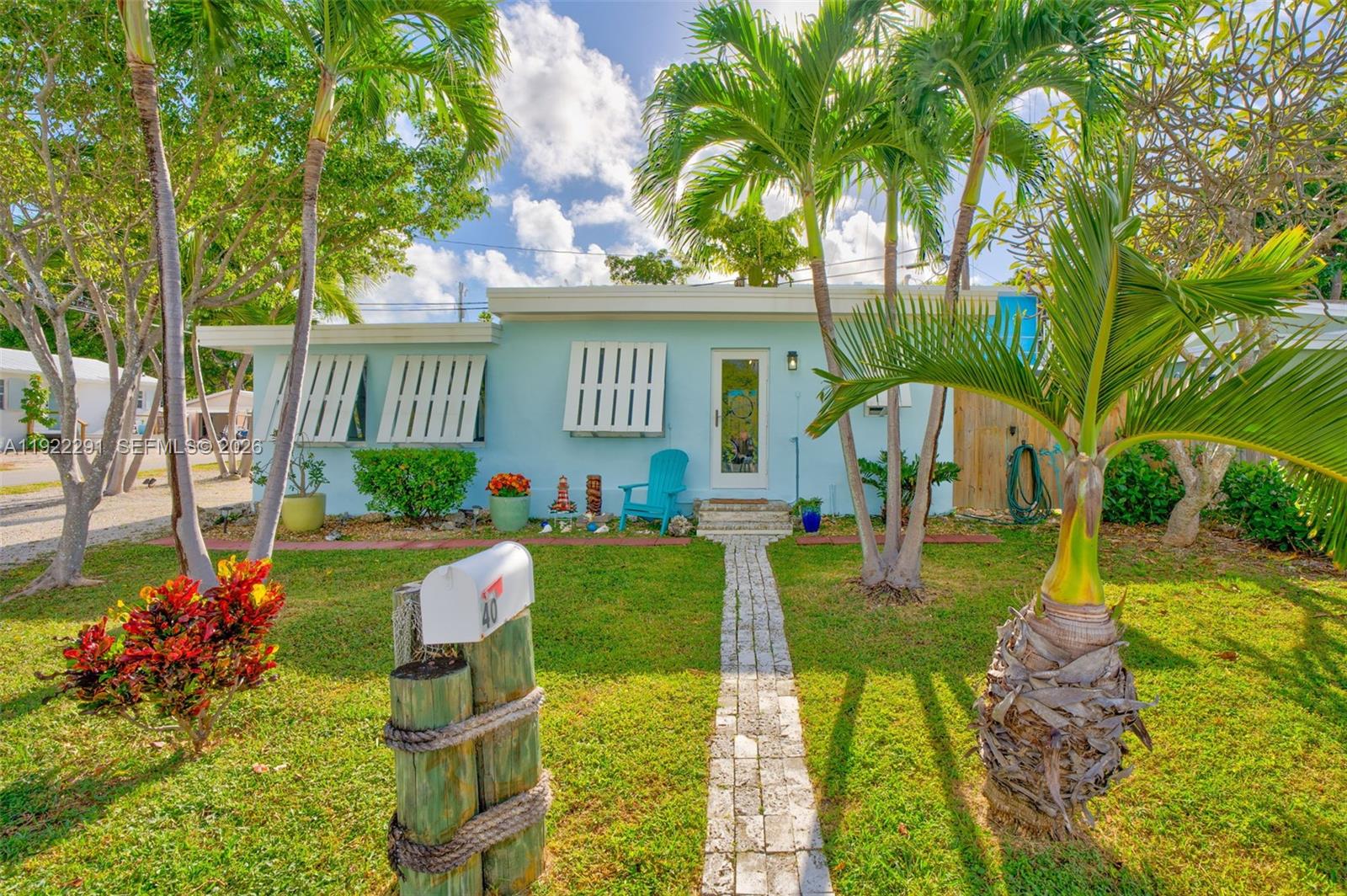a view of a house with a yard and a garden
