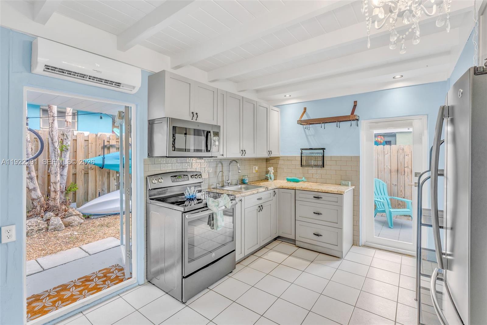 40 Pirates Drive Key Largo, FL 33037 - Photo 12 of 38 a kitchen with white cabinets a counter space and stainless steel appliances