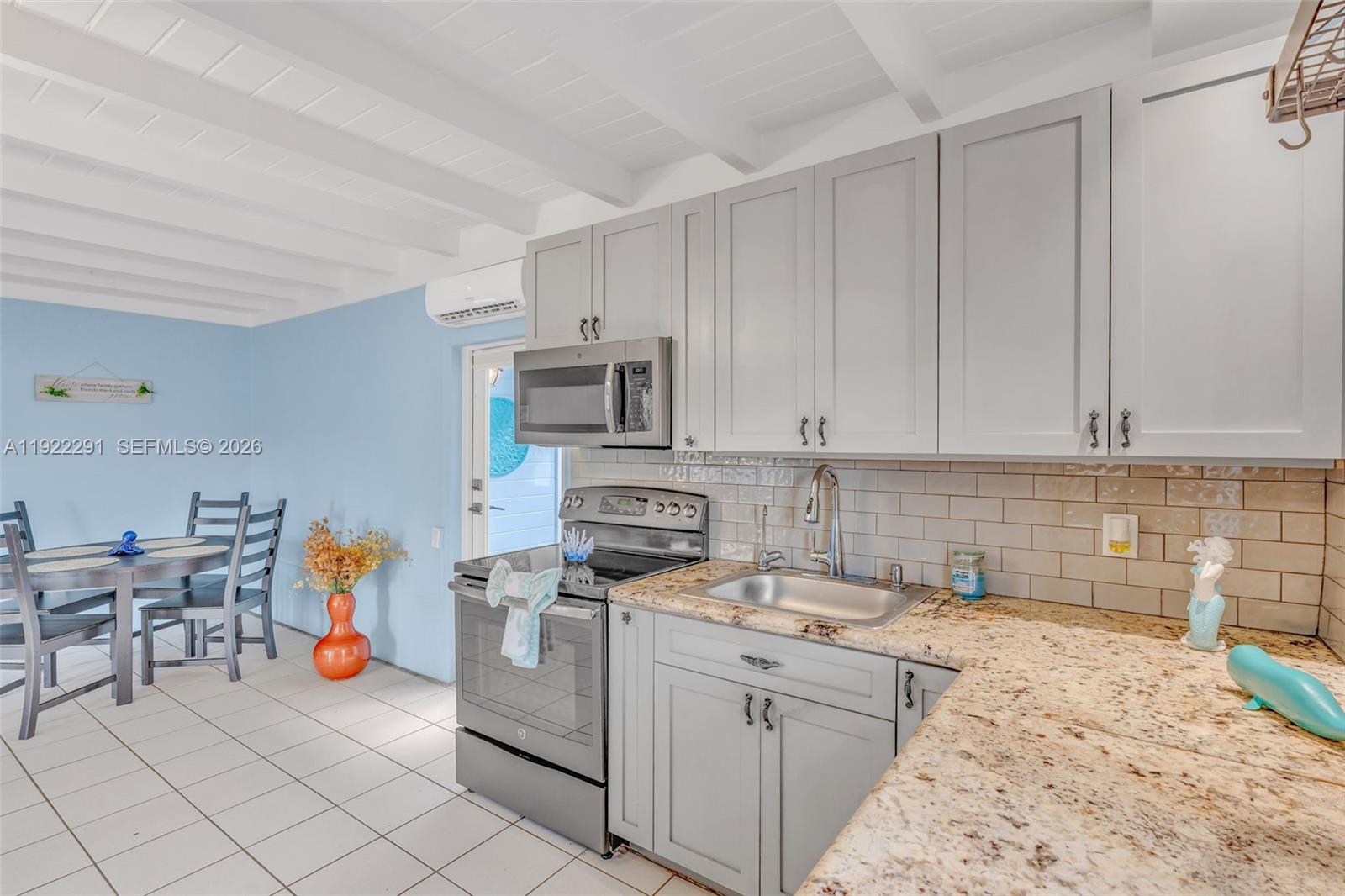 40 Pirates Drive Key Largo, FL 33037 - Photo 13 of 38 a kitchen that has a lot of cabinets in it and appliances